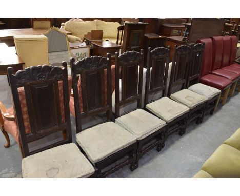A set of six 18th Century oak panel back dining chairs on bobbin turned supports and cross stretchers. 