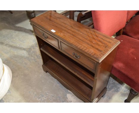 A reproduction mahogany book case with two drawers and a single open shelf. 
