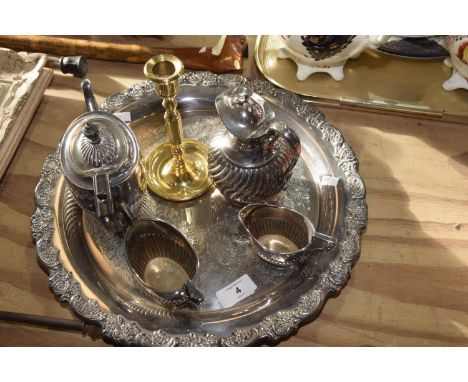 An EPNS tea service Six items to include a hot water jug, tea pot, sugar bowl and milk jug, brass candle stick and circular t