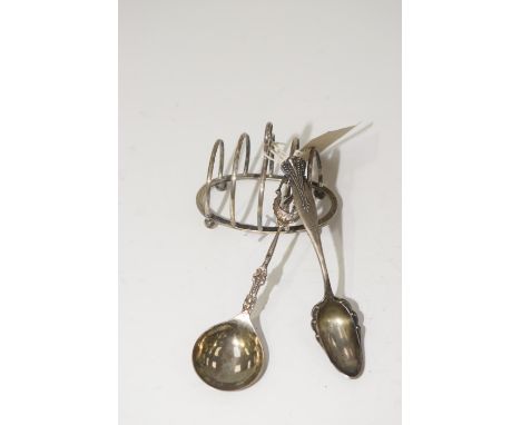 A selection of silver and white metal itemsTo include a George V silver toast rack, and two white metal spoons, toast rack wi