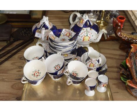 A Gaudy Welsh tea service Comprising of circular platter, tea pot, twelve teacups and matching saucers, three egg cups, twin 