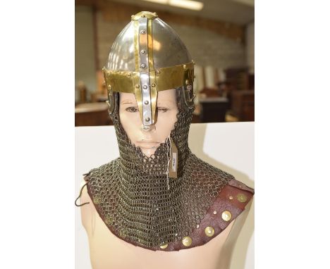 A reproduction Norman or Viking helmet, riveted with brass banding and complete with a chain link neck protector, along with 