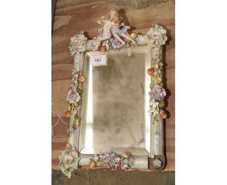 A Meissen style porcelain easel mirrorThe rectangular beveled mirrored plate within a porcelain frame applied with a pair of 