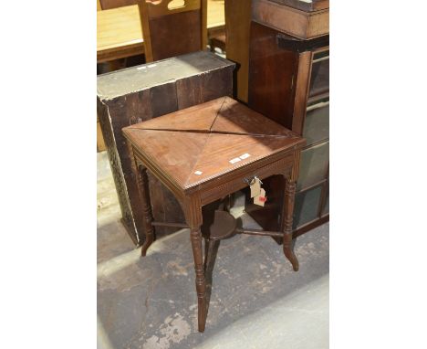 An Edwardian mahogany envelope card tableThe envelope folding top enclosing a baize lined playing surface 