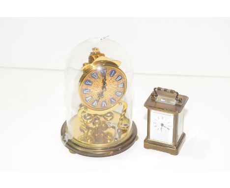 A miniature brass cased carriage clock by Mathew Norman , London along with a brass torsion clock having a gilt metal dial an