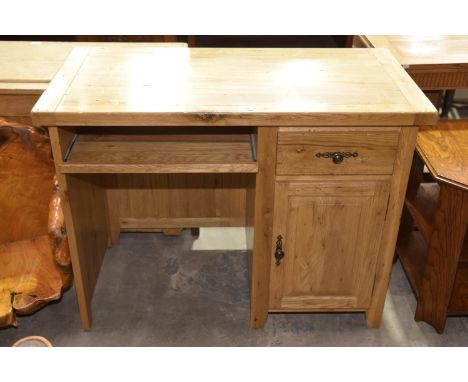 A contemporary light oak computer desk. 