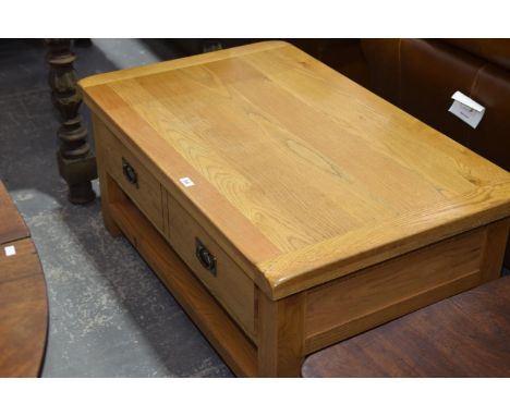 A contemporary light oak coffee tableWith a slab top, single frieze drawer and lower shelf. 