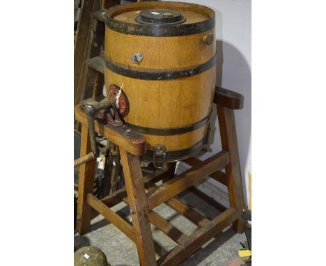 An early 20th Century oak and metal banded barrel butter churn buy Wade & Sons, Leeds Supported on a pitch pine frame. 