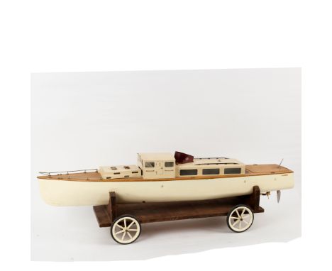 A steam operated single prop model steam ship with spirit heated engine and teak deck, on a four wheeled stand, 132cm long