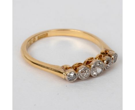 A diamond five-stone ring, the graduated stones in a millegrain setting to an 18ct yellow gold shank, size N