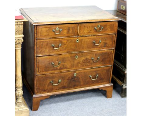 An early 18th Century walnut chest of three long and two short drawers with geometric banding throughout, on bracket feet, 89