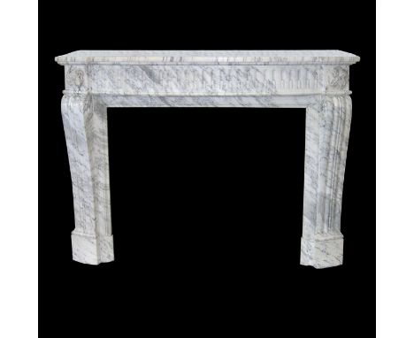 A carved Louis XVI style chimneypiece in Arabascato marble with breakfront mantel, fluted frieze and fluted scroll top jambs,