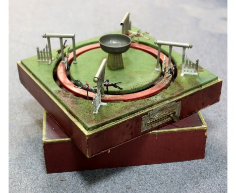 A French mechanical horse racing game by Jouet de Paris, 38cm wide and a toy cannon