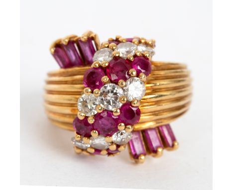 A ruby and diamond dress ring by Kutchinsky, of stylised form set with bands of alternating rubies and diamonds and with thre