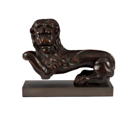 A carved oak model of a lion, 16th/17th Century, modelled as resting on his back legs with extended front paws, on rectangula