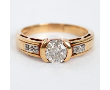 A diamond ring, the principal stone of approximately 1ct, with two small diamonds to each shoulder, set in 9ct yellow gold, s