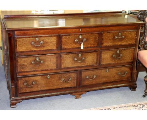 An oak blanket chest with three false drawers, three short drawers and two long drawers, on bracket feet, 165cm wide