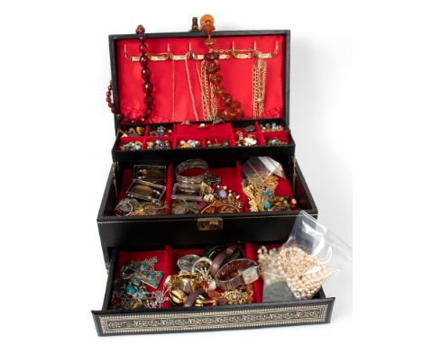 A large quantity of costume jewellery including amber necklaces, faux pearls, watches, an enamel badge 'Anno Jubilae MCMXXV i