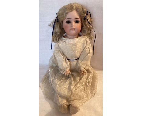 Simon &amp; Halbig: A Simon &amp; Halbig / Kammer &amp; Reinhardt, bisque head doll, composition body with walking mechanism.