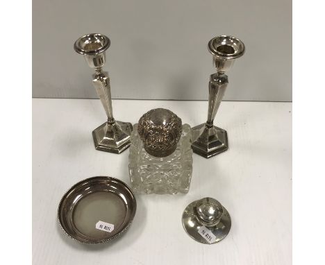 A silver mounted cut glass inkwell with embossed lid, together with a silver capstan inkwell of small proportions, a silver p