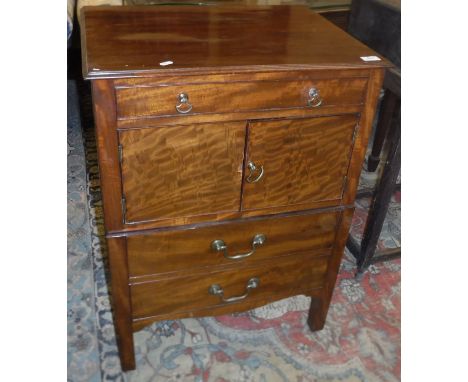 A late George III mahogany night table, the top with moulded edge over a dummy drawer and two cupboard doors over a commode d