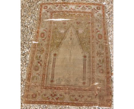 A Turkish silk prayer rug with centre architectural medallion on a pale green ground, within a cream ground, green, red and g