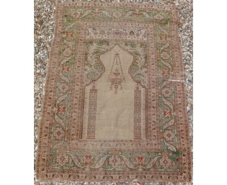 A Turkish silk prayer rug with architectural and lantern centre field on a green ground, within a green ground foliate decora