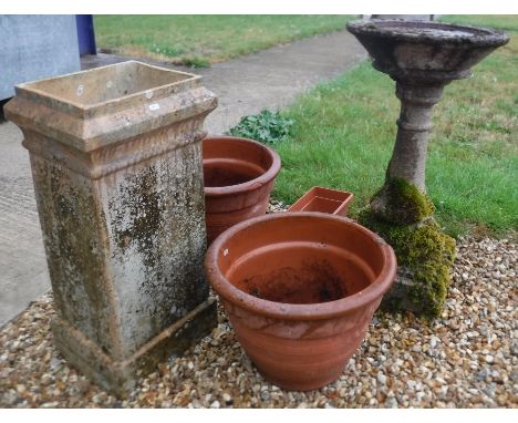 A reconstituted stone bird bath, 45.5 cm diameter x 84 cm high, a rectangular pale terracotta chimney pot of tapered rectangu