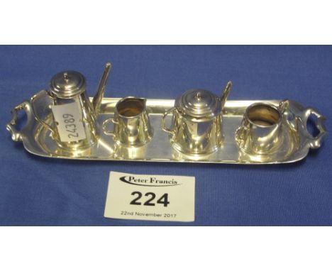 Miniature silver five piece tea and coffee service comprising: twin handled tray; teapot; coffee pot; cream jug and twin hand