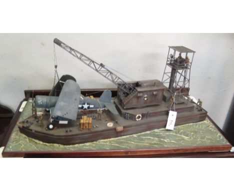 Scale model Diorama of an American Recovery Barge with crane and Chance Vought Corsair Air Craft on a rectangular, naturalist