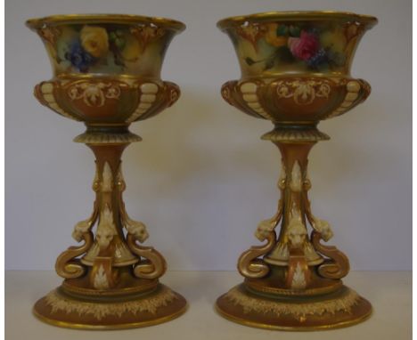 Pair of Royal Worcester Hadley style goblet vases with handpainted floral decoration and figural scroll pedestal base, circa 
