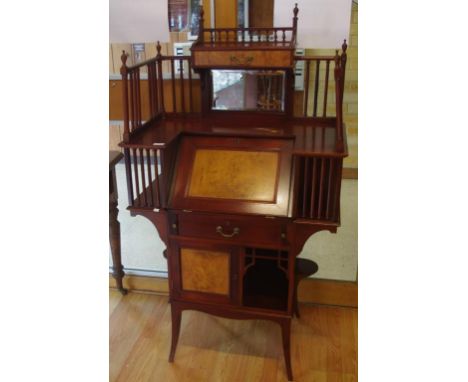 Arts & Crafts style bureau desk with mirrored gallery back, a fall front writing surface with fitted interior above a drawer,