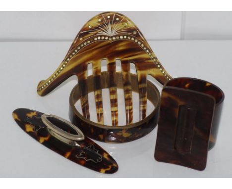 Vintage tortoiseshell napkin ring together with other tortoiseshell items and a faux tortoiseshell hair comb