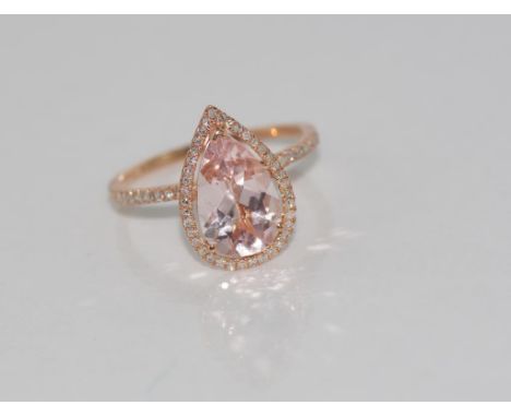 10ct rose gold and Morganite ring with grain set diamond surround and to top of band, weight: approx 2.6 grams, size: 8/Q-R