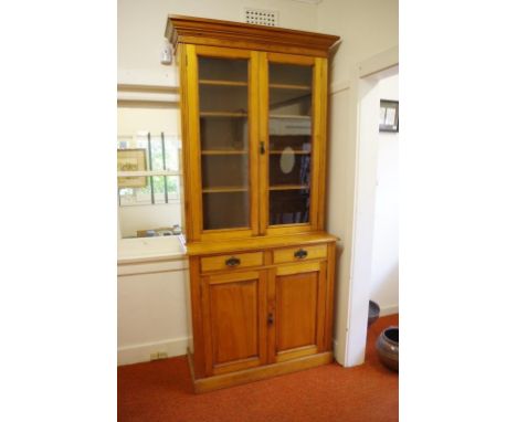 Antique pine elevated bookcase with enclosed bookcase above 2 drawers and a 2 door cabinet, 106cm wide, 47cm deep, 235cm high