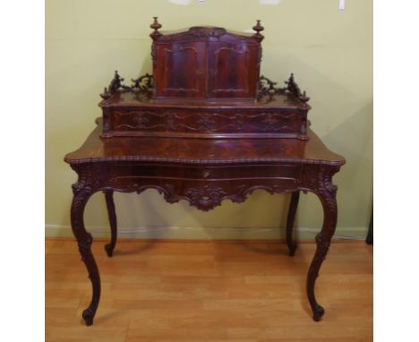 Rococo style mahogany desk with various drawers and compartments, also a pull out writing surface, 115cm wide, 136cm high