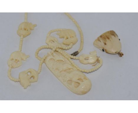 Vintage ivory pendant in the shape of a shark head together with a bone elephant necklace