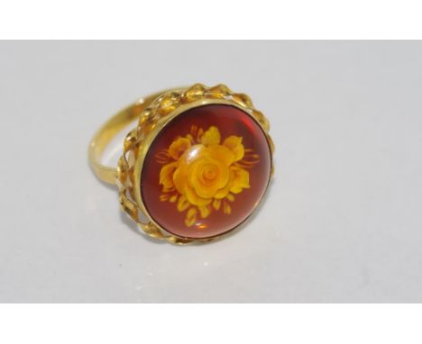 Carved amber flower ring set in silver gilt, size: R-S/8-9