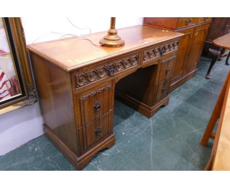 Light oak Old Charm style linen fold fronted desk, carvings throughout 