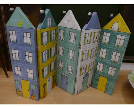 Folding wooden panel formed as houses 