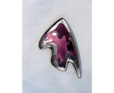 A Georg Jensen silver brooch: stylised fish, with body in shades of pink enamel, designed by Henning Koppel, stamped on raise