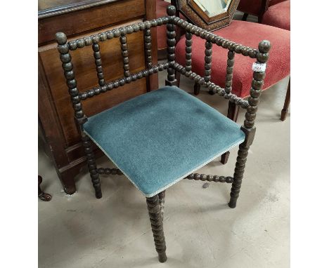 A bobbin turned corner armchair of small proportions, upholstered in blue 