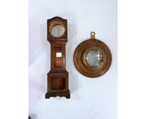 A watch stand in the form of a miniature longcase clock, height 30 cm; a wall clock/barometer case in turned walnut and brass