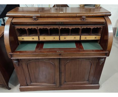 A Victorian mahogany, cylinder top bureau with a slide out writing surface &amp; sateen beech lined fitted interior, double c