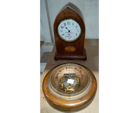 An Edwardian mantel clock in lancet top Sheraton inlaid mahogany case, with balance spring movement, height 23 cm; an aneroid