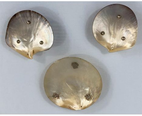 A Chinese pair of ashtrays in mother-of-pearl with silver coin feet, 8.5 cm; another similar, 11 cm 