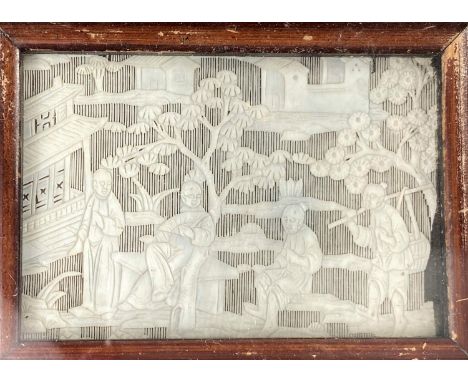 An early 20th century Chinese small rectangular panel in delicately carved and pierced ivory, depicting figures in a garden, 