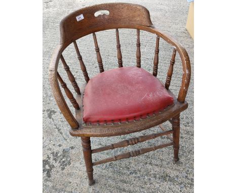 An oak smoker's / captain's stick back bow armchair with red effect leather cushion seat 