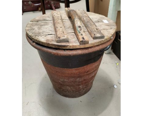 A 19th century large terracotta bread mug with slatted wooden lid.&nbsp; It sounds as though it has a hairline crack.&nbsp; S