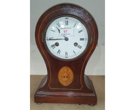 An Edwardian striking mantel clock in inlaid mahogany balloon shaped case 